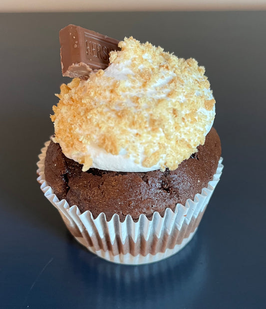S'mores Cupcake - A chocolate cupcake with graham cracker crust, filled and topped with a marshmallow frosting.
