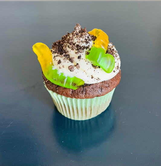 Dirt pudding cupcake - A rich chocolate cupcake filled chocolate pudding. Topped with buttercream icing, oreo crumbs and gummy worms.