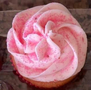 Strawberry - A strawberry cake with real strawberries mixed in, strawberry buttercream icing, topped with a strawberry. Speciality option - filled with strawberry jam or icing.