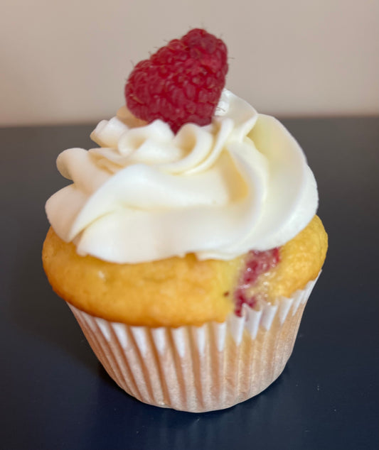 Raspberry - A vanilla based cake with raspberries mixed in and buttercream icing topped with a raspberry. Speciality option - filled with raspberry jam or icing, with raspberry drizzle. (Also available in chocolate)